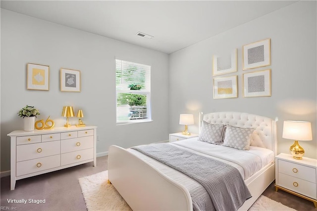 carpeted bedroom with baseboards and visible vents