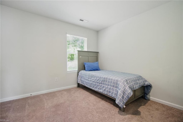 bedroom featuring baseboards, carpet flooring, and visible vents
