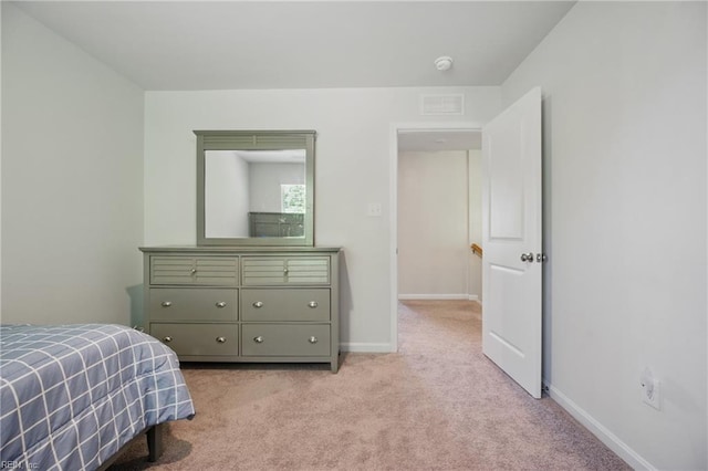 bedroom with light colored carpet, baseboards, and visible vents