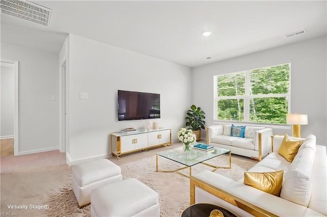 carpeted living room featuring baseboards and visible vents