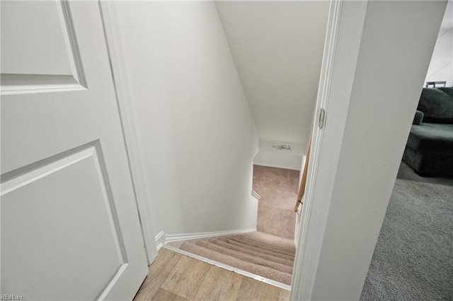 stairs with carpet flooring and wood finished floors