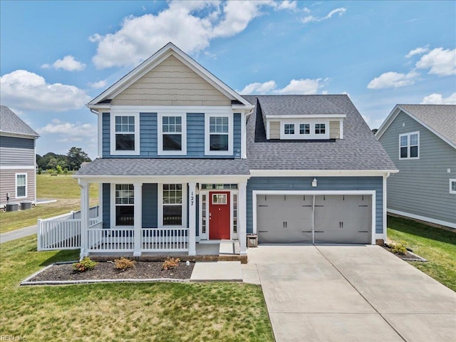 view of front of property with covered porch, driveway, a garage, a front yard, and a shingled roof