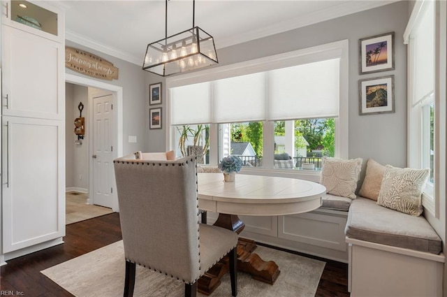 dining room with plenty of natural light, a chandelier, ornamental molding, and dark wood-type flooring