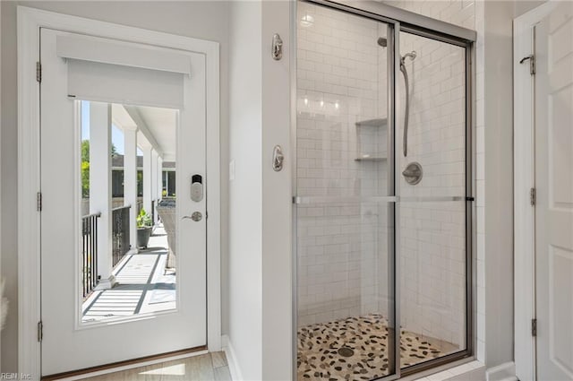 full bathroom with baseboards and a shower stall