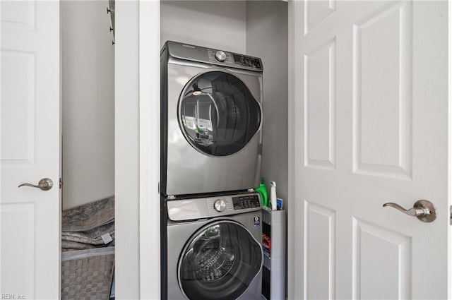laundry area featuring stacked washer / dryer