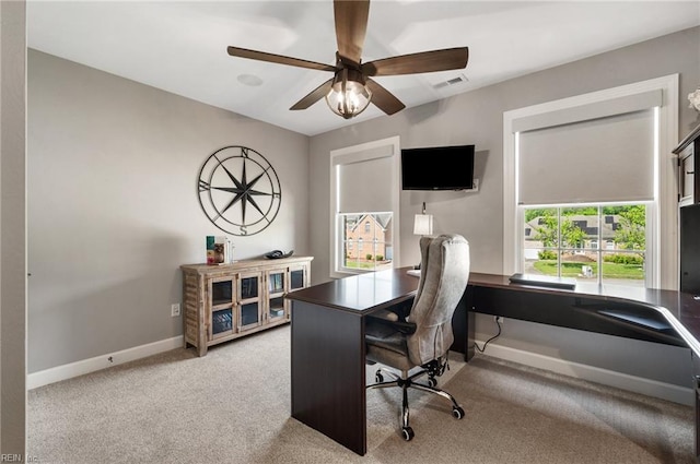 office with visible vents, baseboards, ceiling fan, and carpet floors