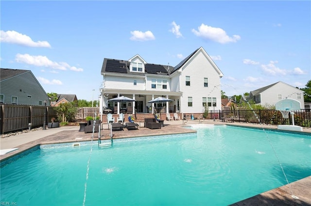 view of swimming pool featuring outdoor lounge area, a patio, a fenced in pool, and a fenced backyard