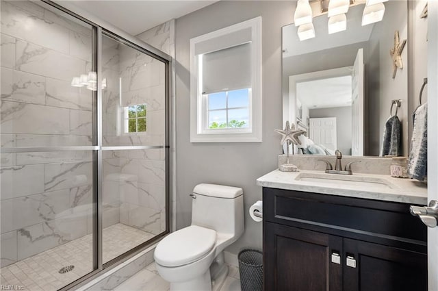 full bath with a stall shower, vanity, baseboards, toilet, and marble finish floor