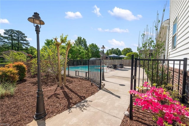 view of swimming pool featuring fence, a patio area, and a fenced in pool