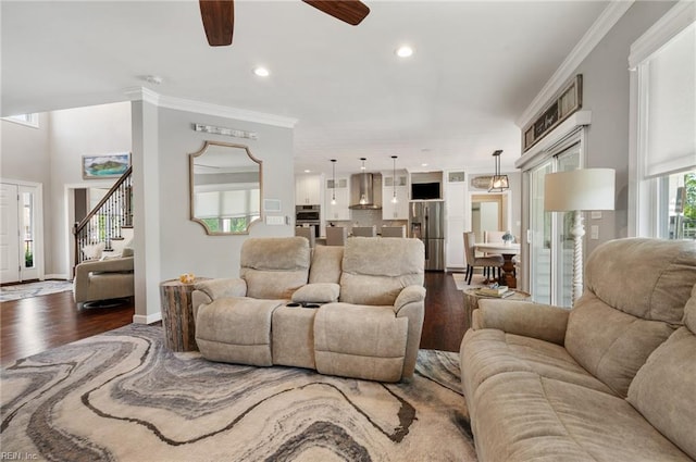 living room featuring ornamental molding, a ceiling fan, recessed lighting, and dark wood-type flooring