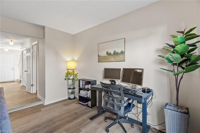 office with baseboards and wood finished floors