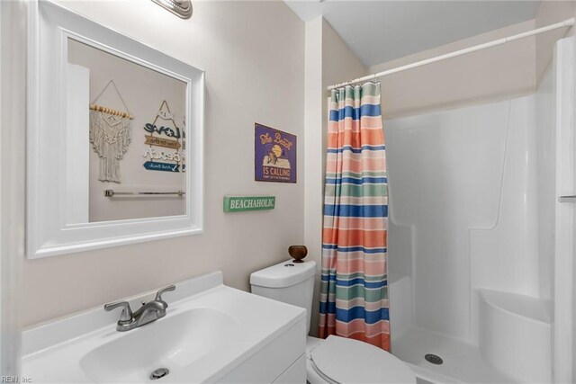 full bathroom featuring vanity, curtained shower, and toilet
