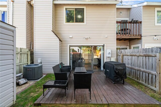 back of property with a fenced backyard, central AC unit, and a wooden deck
