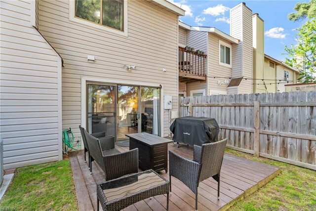wooden deck with fence and a grill
