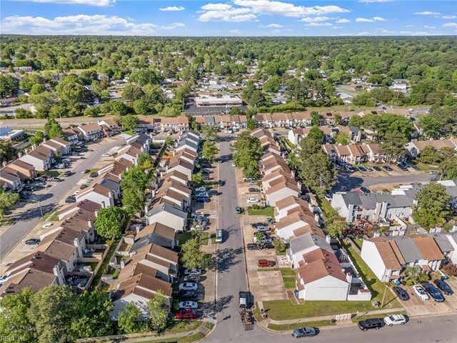 drone / aerial view featuring a view of trees and a residential view