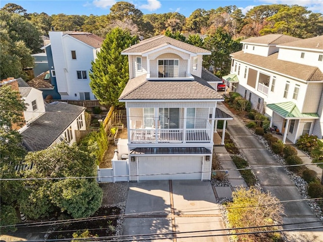 8506 Atlantic Ave Unit B, Virginia Beach, VA 23451 - back of property featuring concrete driveway, fence, a shingled roof, and a garage