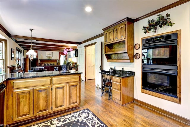 kitchen featuring dobule oven black, brown cabinetry, crown molding, and wood finished floors