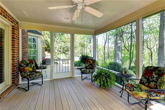 sunroom featuring ceiling fan