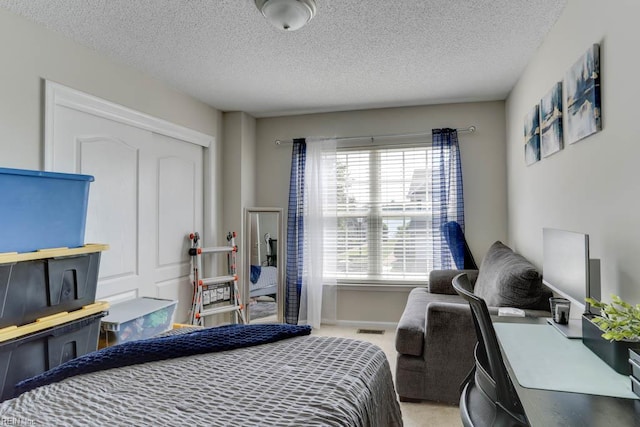 carpeted bedroom with a textured ceiling