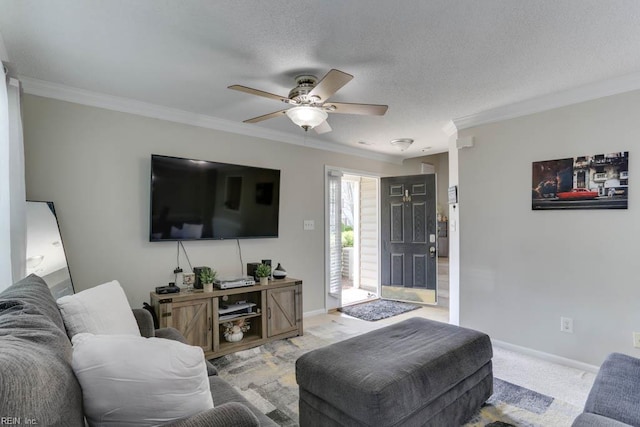 living room featuring crown molding, a ceiling fan, baseboards, and a textured ceiling