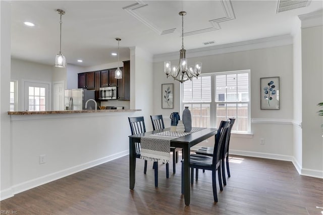 dining space featuring crown molding, visible vents, and plenty of natural light
