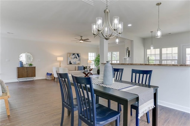 dining room featuring recessed lighting, baseboards, wood finished floors, and ceiling fan with notable chandelier