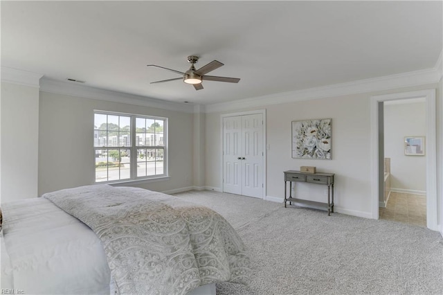 carpeted bedroom featuring baseboards, ornamental molding, a closet, and visible vents