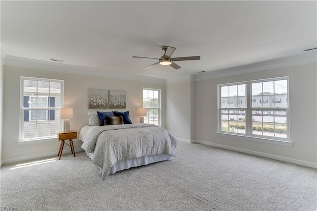 bedroom featuring baseboards, ornamental molding, carpet, and visible vents