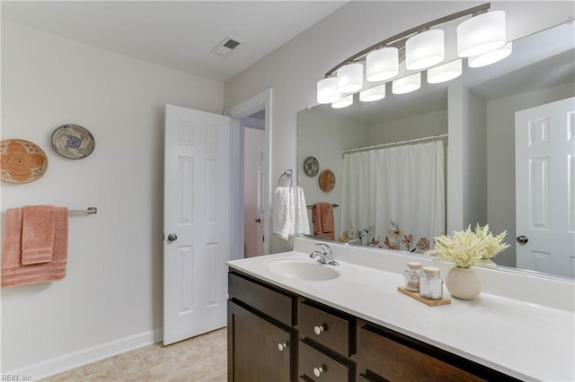 full bathroom featuring baseboards, tile patterned flooring, visible vents, and vanity
