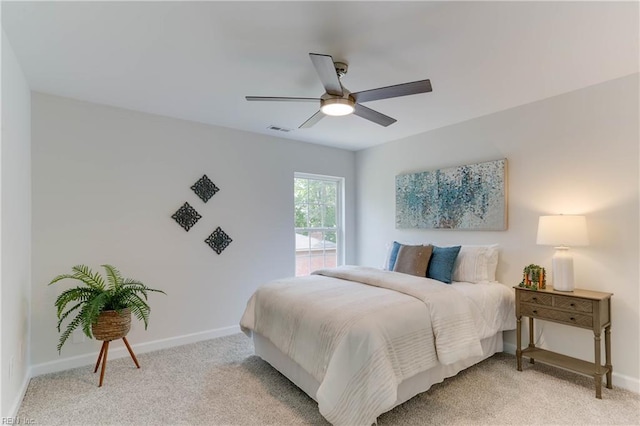 bedroom with baseboards, light colored carpet, and visible vents