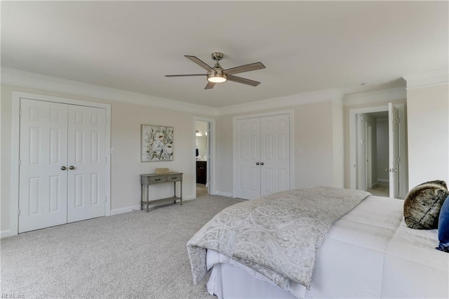 bedroom with crown molding, light carpet, multiple closets, a ceiling fan, and baseboards