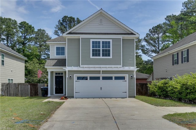 view of front facade with concrete driveway, fence, a front yard, and a garage