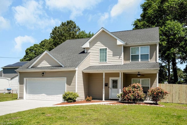 view of front facade with driveway, roof with shingles, fence, a front lawn, and an attached garage
