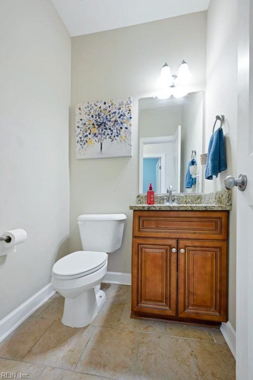 half bathroom featuring toilet, baseboards, tile patterned floors, and vanity