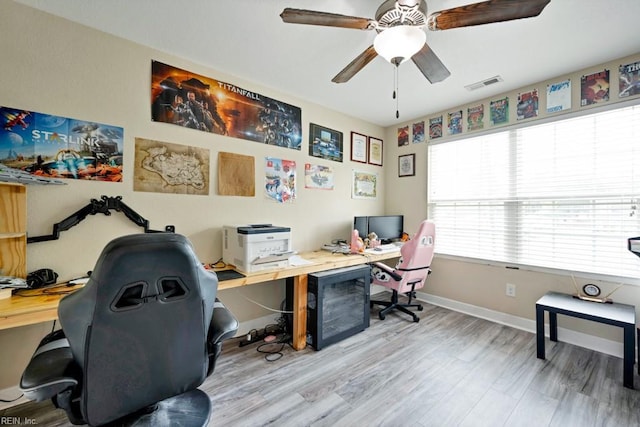 home office featuring a ceiling fan, baseboards, visible vents, and wood finished floors