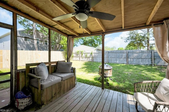 sunroom / solarium featuring plenty of natural light and ceiling fan