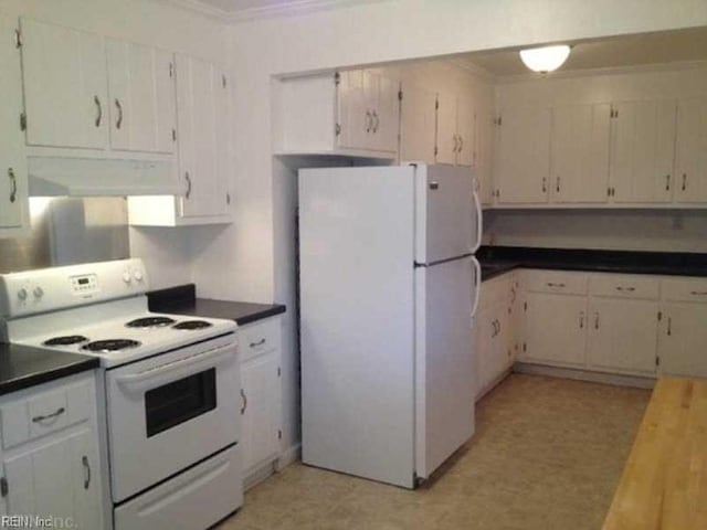 kitchen featuring dark countertops, light floors, ornamental molding, white appliances, and extractor fan