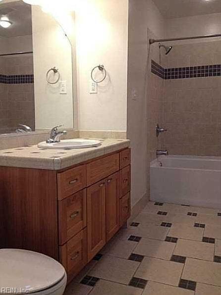 bathroom featuring vanity, tile patterned floors, bathtub / shower combination, and toilet