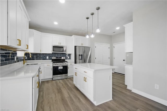 3612 Purebred Dr, Virginia Beach, VA 23453 - kitchen with a sink, stainless steel appliances, white cabinetry, decorative backsplash, and wood finished floors