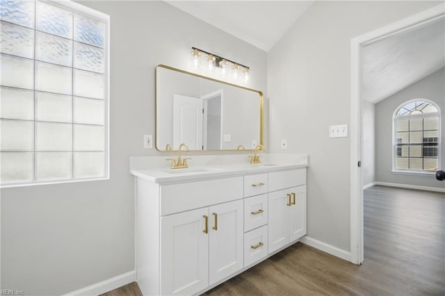 3612 Purebred Dr, Virginia Beach, VA 23453 - bathroom featuring a sink, double vanity, baseboards, wood finished floors, and vaulted ceiling