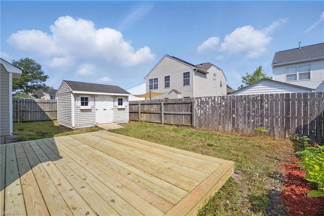 3612 Purebred Dr, Virginia Beach, VA 23453 - wooden deck with an outdoor structure, a lawn, a fenced backyard, and a storage unit