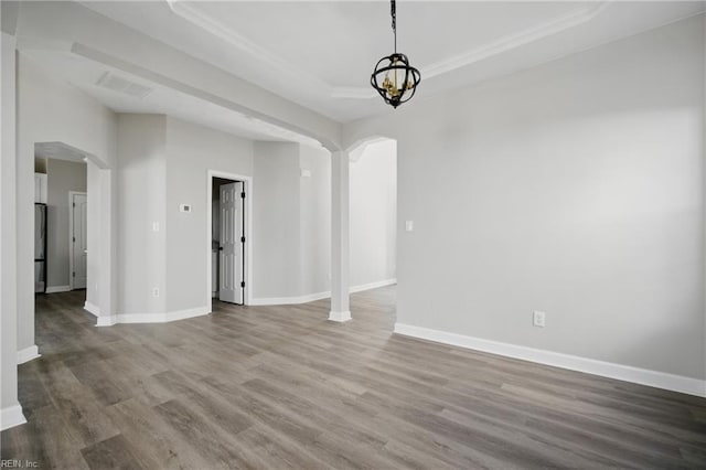3612 Purebred Dr, Virginia Beach, VA 23453 - unfurnished dining area with visible vents, wood finished floors, baseboards, a tray ceiling, and arched walkways