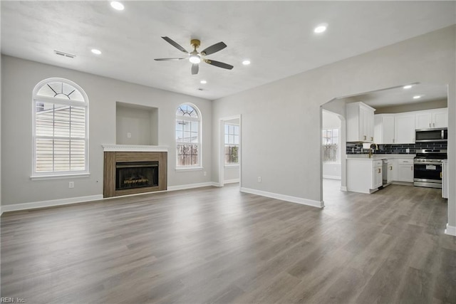 3612 Purebred Dr, Virginia Beach, VA 23453 - unfurnished living room with baseboards, ceiling fan, wood finished floors, and visible vents