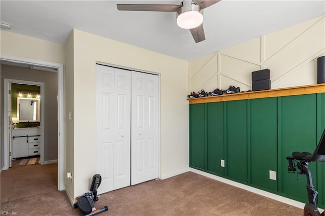unfurnished bedroom featuring carpet floors, a ceiling fan, baseboards, and a closet