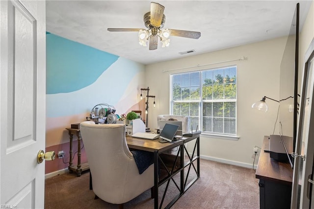 office space featuring carpet floors, baseboards, a ceiling fan, and visible vents