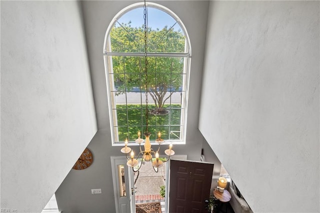 foyer with a high ceiling and a notable chandelier