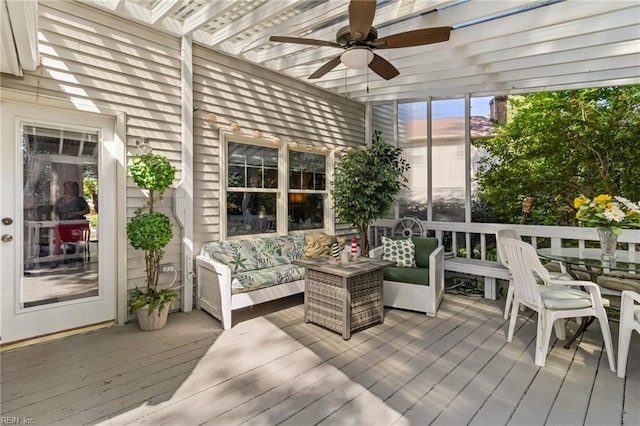 sunroom / solarium with a ceiling fan and an outdoor hangout area