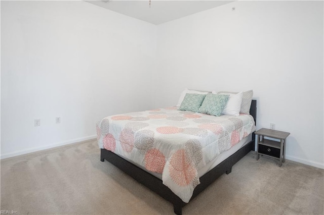 bedroom with baseboards and carpet