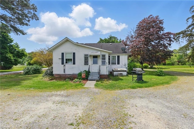 bungalow-style house with a front lawn