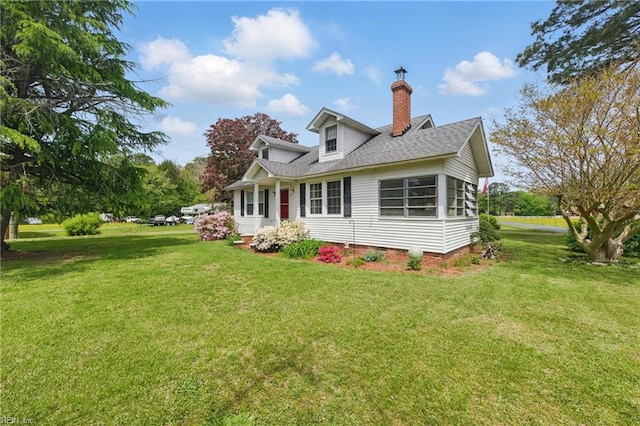 view of home's exterior featuring roof with shingles, a yard, and a chimney